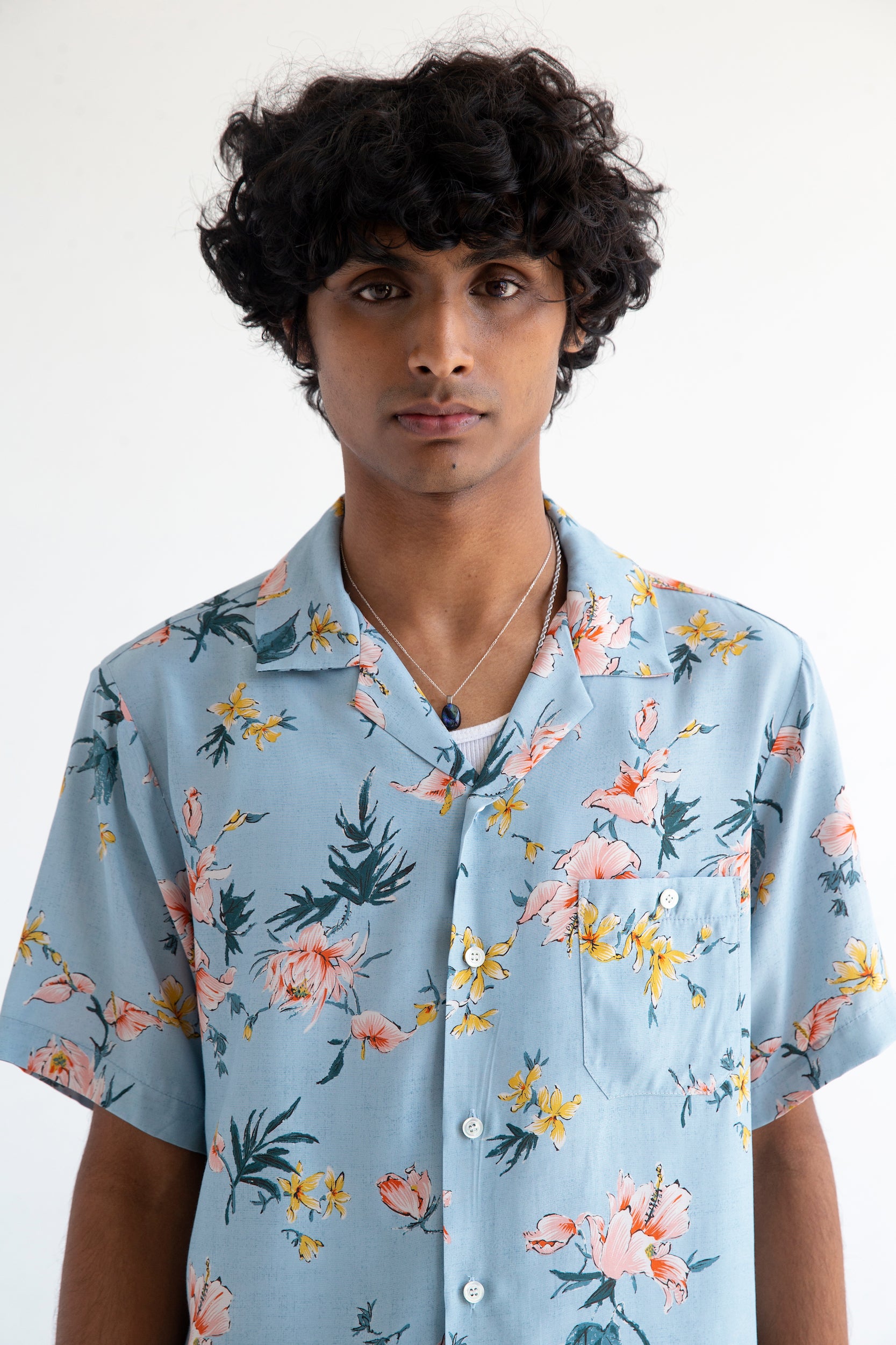 collar detail of light blue floral printed shirt